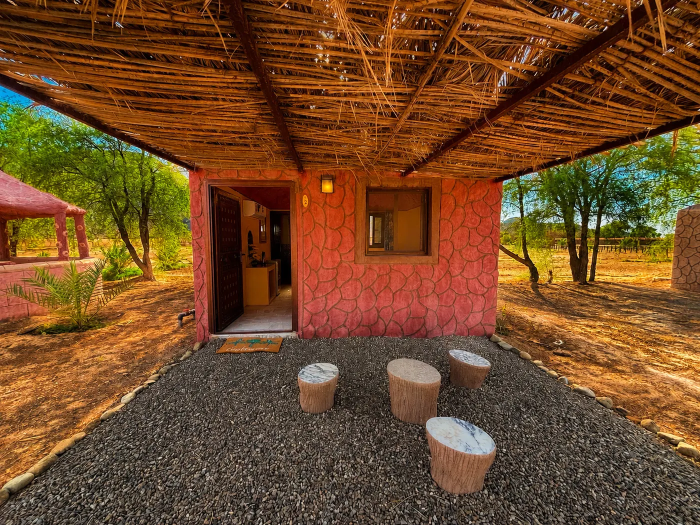 Shaded porch with log stools